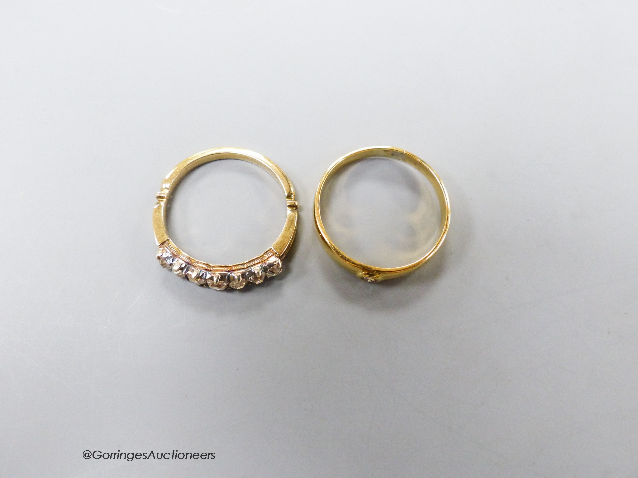 A yellow metal and graduated seven stone diamond set half hoop ring, size O and one other solitaire diamond set ring, gross 6.2 grams.